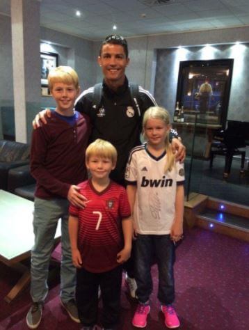 Elijah Solskjaer and his siblings Noah and Karna with Cristiano Ronaldo.